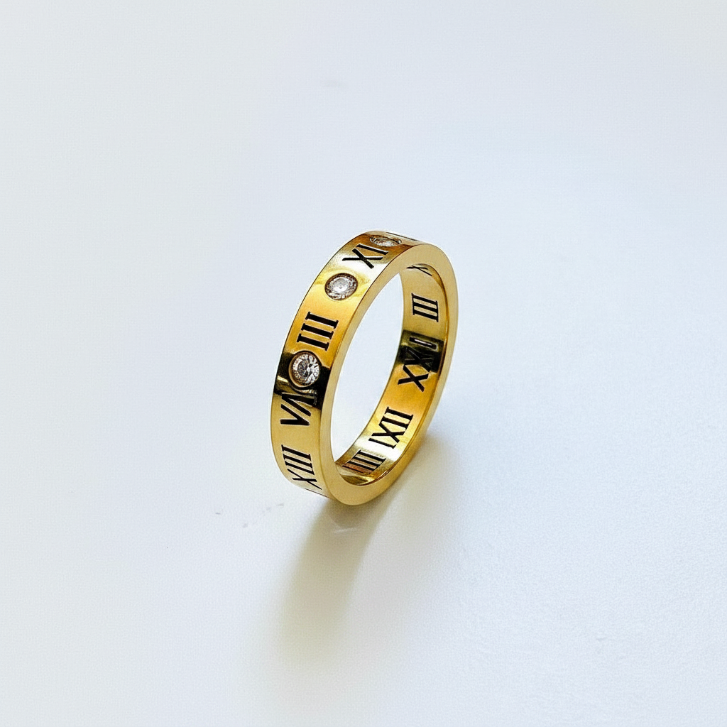 Romani Luck gold Roman numeral ring with crystal accent — studio shot